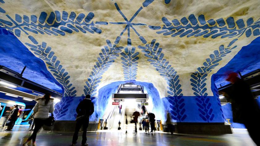 People walk at the T-Centralen subway station on November 6, 2012 in Stockholm, Sweden, decorated in 1975 by artist Per Olof Ultvedt. Over 90 of the 100 subway stations in Stockholm have been decorated with sculptures, mosaics, paintings, installations, engravings and reliefs by over 150 artists. AFP PHOTO / JONATHAN NACKSTRAND